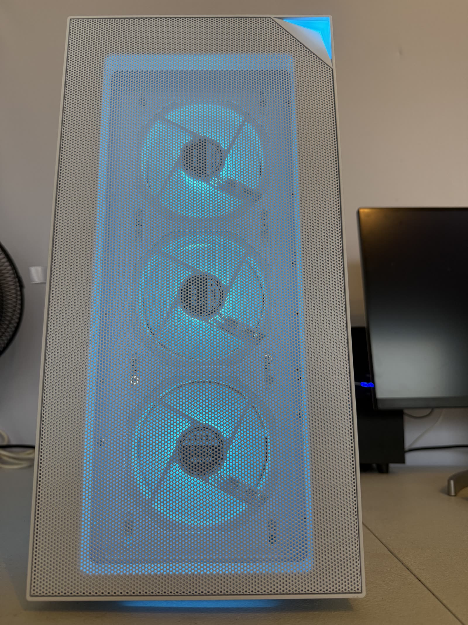White custom PC front view with three cyan-blue RGB fans